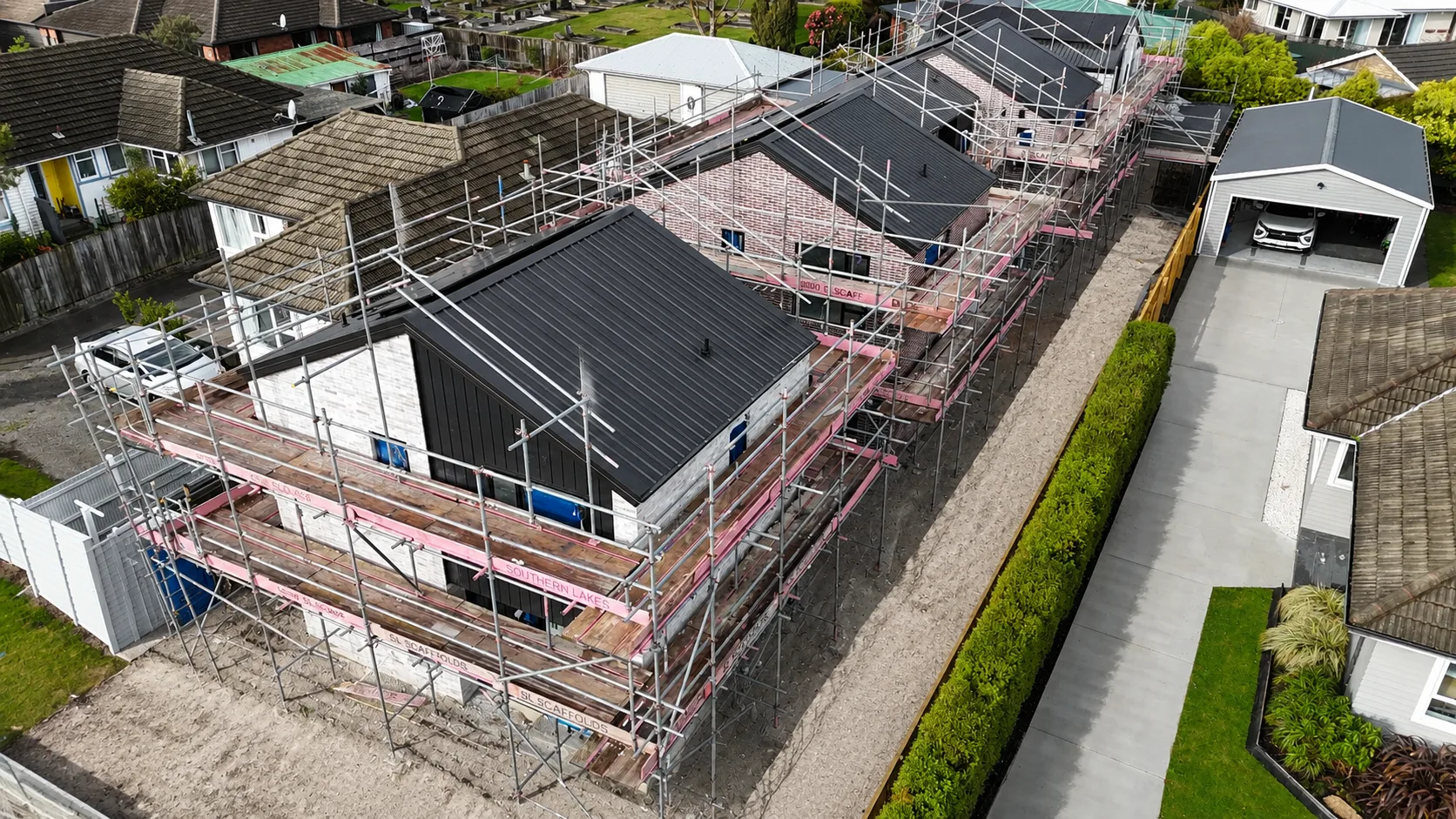 A multi-residential development, a run of townhouses finished in a coordinated exterior palette