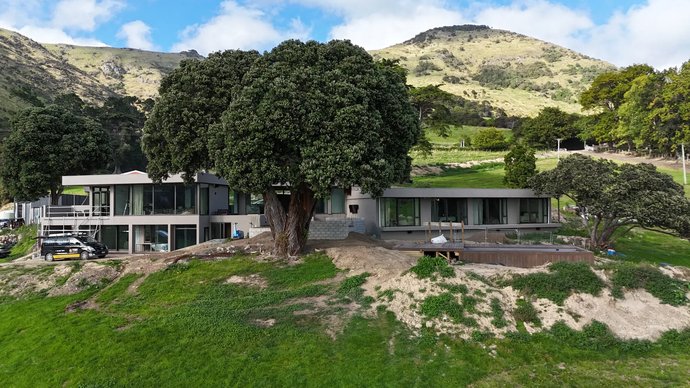 Aerial view of the Little Akaloa home set into the Banks Peninsula coast