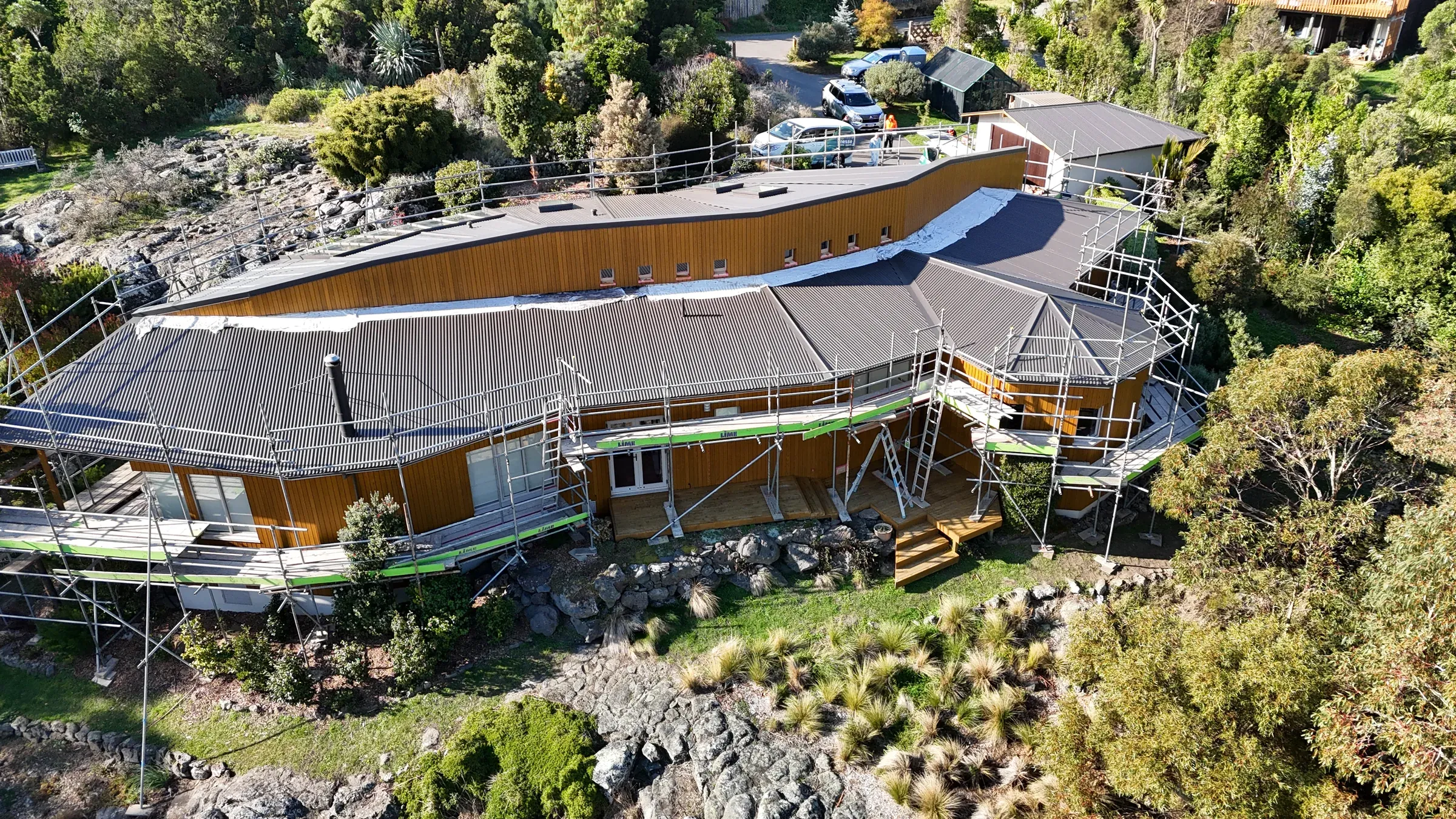 Aerial view of the Rockview home, a curved-roof cedar-clad house on a Canterbury hillside
