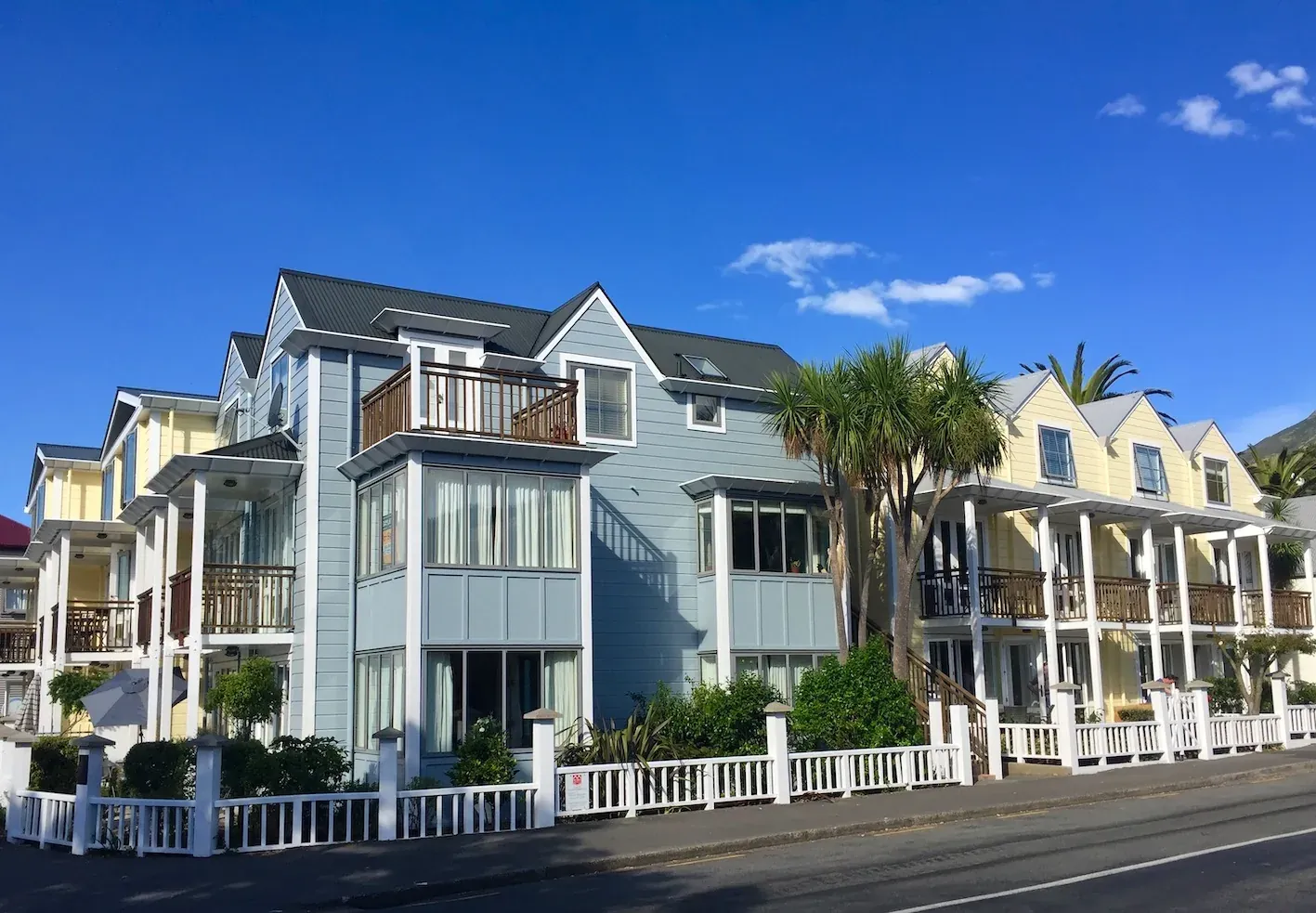 Bruce Waterfront Apartments in Akaroa, pale blue weatherboard exterior