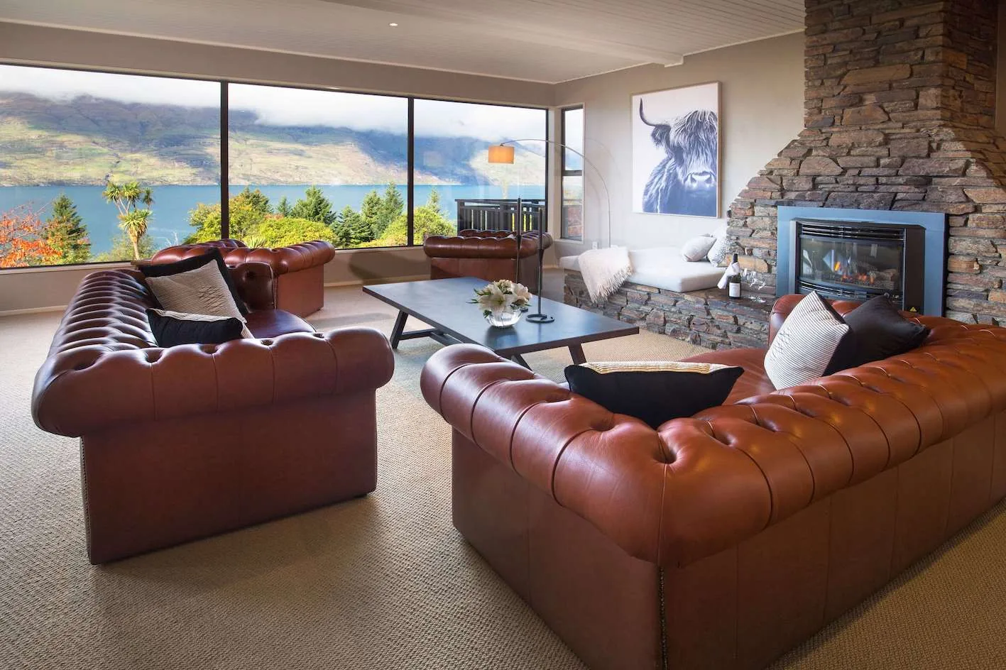 Lounge at Hidden Lodge, Queenstown, with a lake and mountain outlook